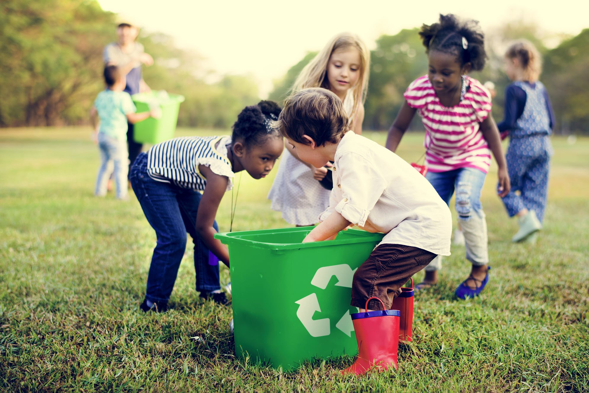 Photo of a Group of Children Recycling in a Park
